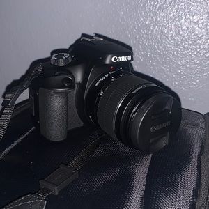 Selling a Canon Rebel T100 Camera with a lot of accessories and a backpack.